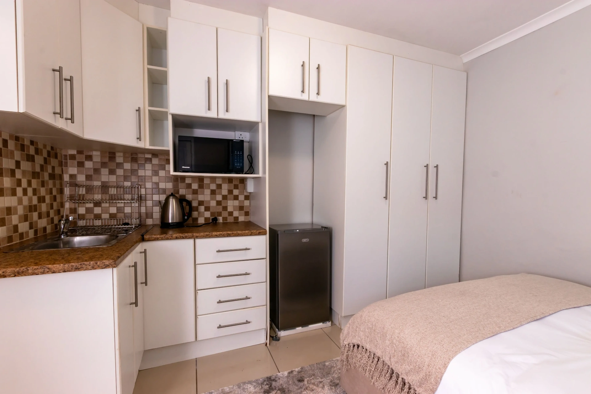 The Signature Room — private kitchenette and wardrobes