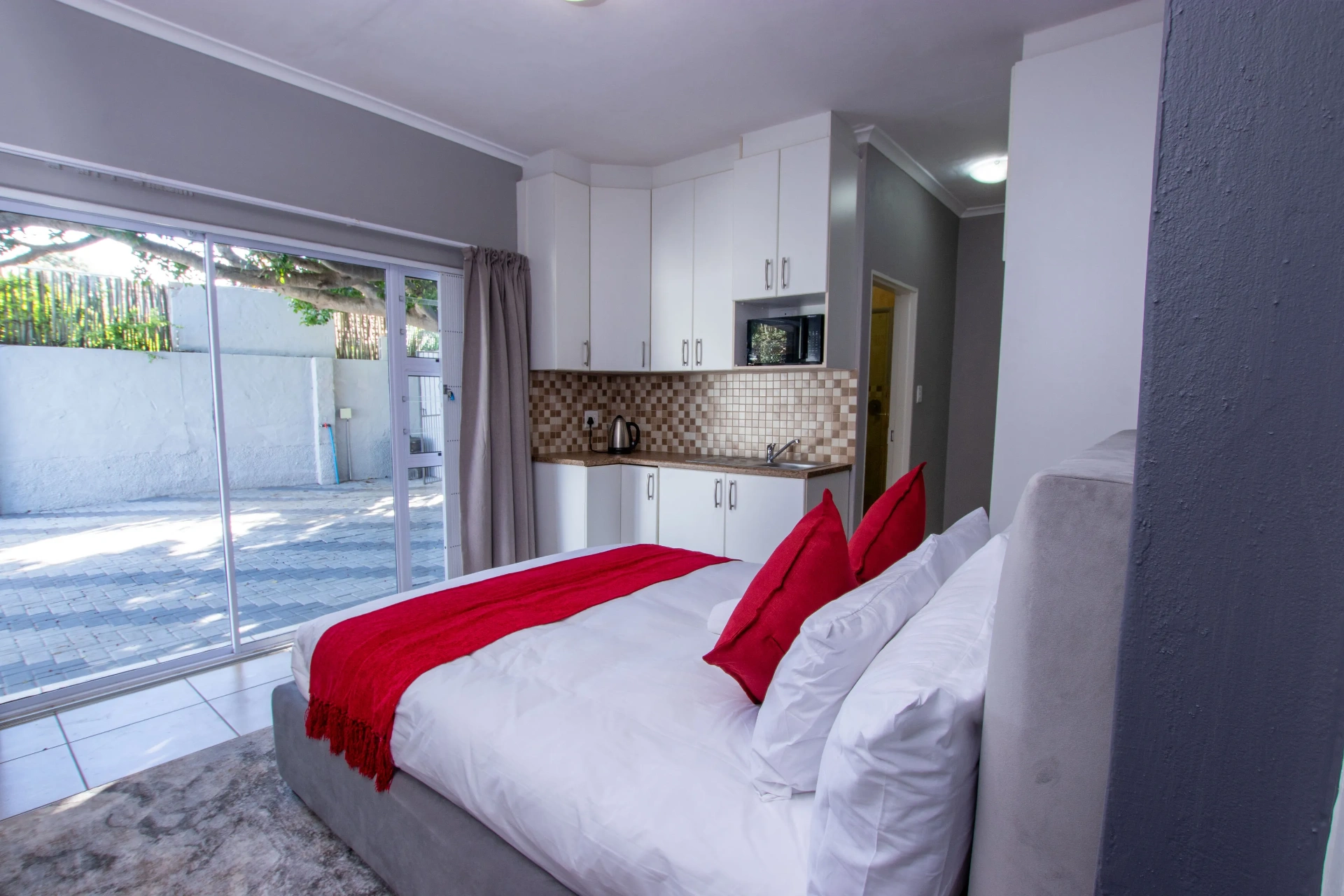 The Serenity Room — bed and sliding doors to courtyard